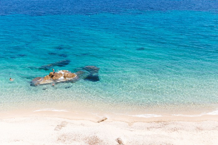 People swimming and playing on Fava Beach, Halkidiki, Greece