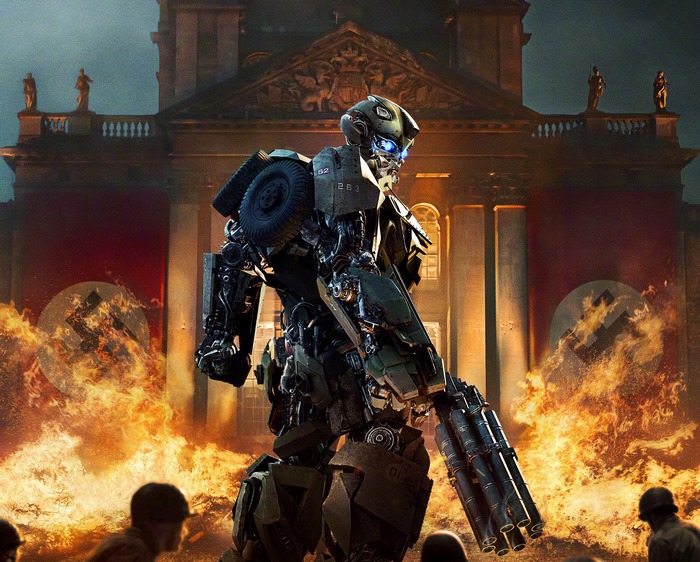 Hot Rod from Transformers: The Last Knight in front of burning building
