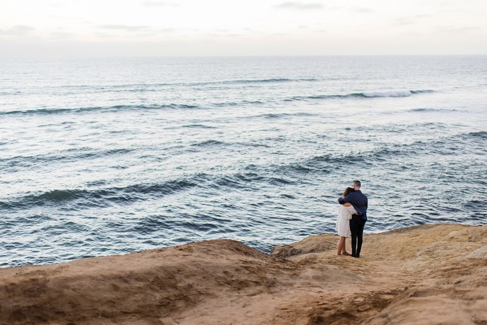 Couple Embracing on a Cliff Overlooking the Ocean in San Diego
