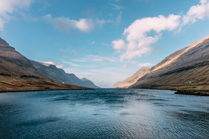 Mountain valley with a lake and clouds