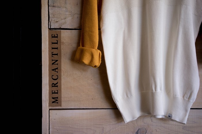 Mercantile wooden box with yellow and white sweaters