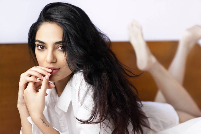 Sobhita Dhulipala lying on a bed