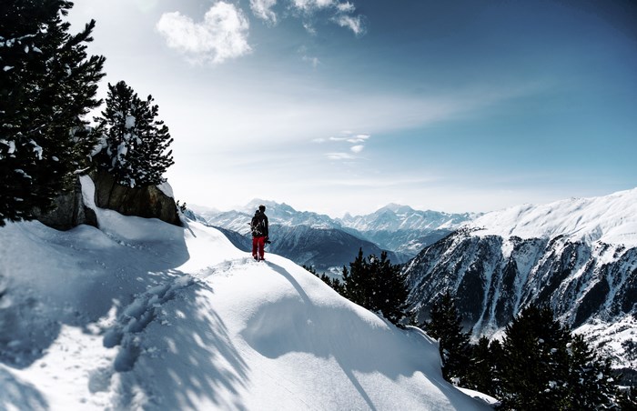 Person hiking on a snowy mountain slope