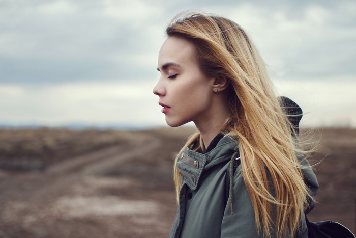 Young woman with blonde hair outdoors