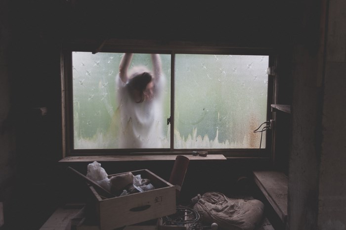 Person behind a frosted window in a shed