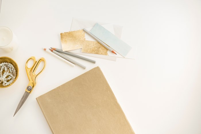 Minimalist Workspace with Gold Scissors and Stationery
