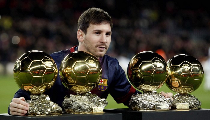 Lionel Messi with Four Ballon d'Or Trophies