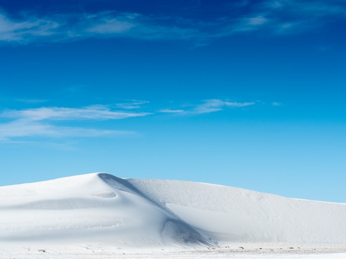 White sand dune under a blue sky
