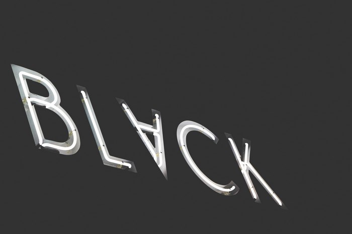 Neon sign spelling BLVCK