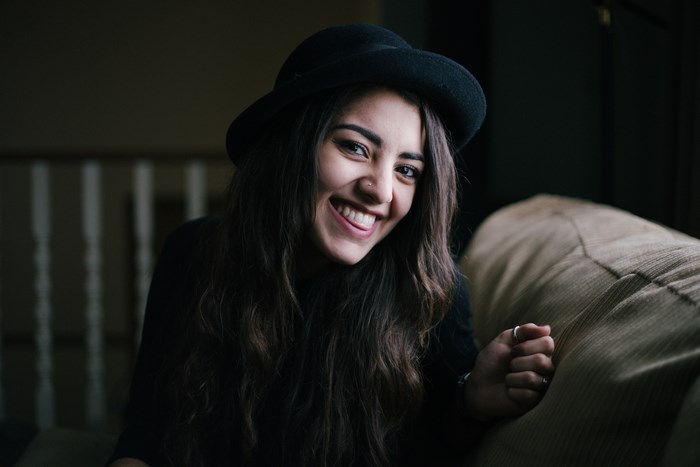 Woman wearing a black hat smiling