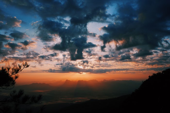 Sunset over mountains with dramatic clouds