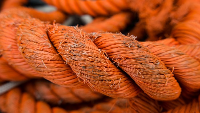 Close-up of a thick, frayed orange rope