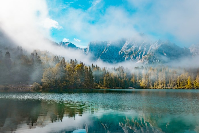 Misty Mountains and Forest Reflected in a Lake