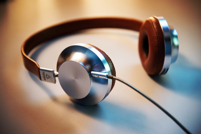 Modern silver and brown leather headphones with cable