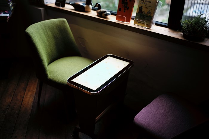 Table and chairs by a window with books