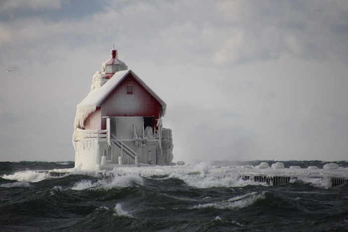 Frozen lighthouse on a stormy sea