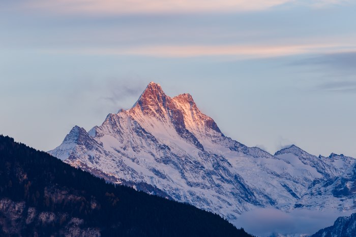 Snow-covered mountain peak at sunset in Switzerland