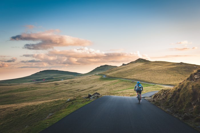 Cyclist on a winding road in the countryside