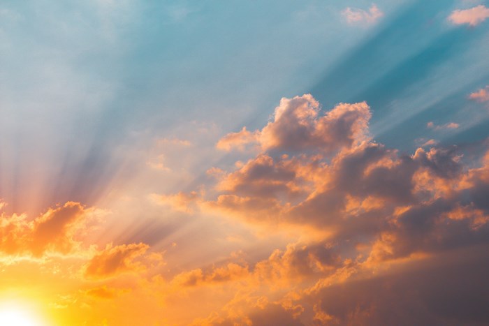 Sunbeams shining through clouds at sunset