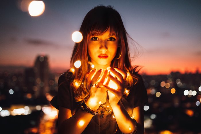 Girl Holding Glowing Fairy Lights at Sunset 4K
