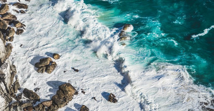 Aerial view of waves crashing on rocks in South Africa
