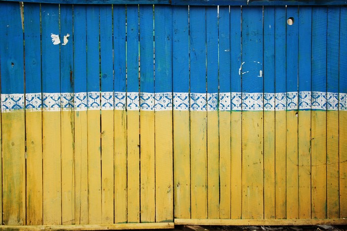 Ukraine flag painted on a wooden fence