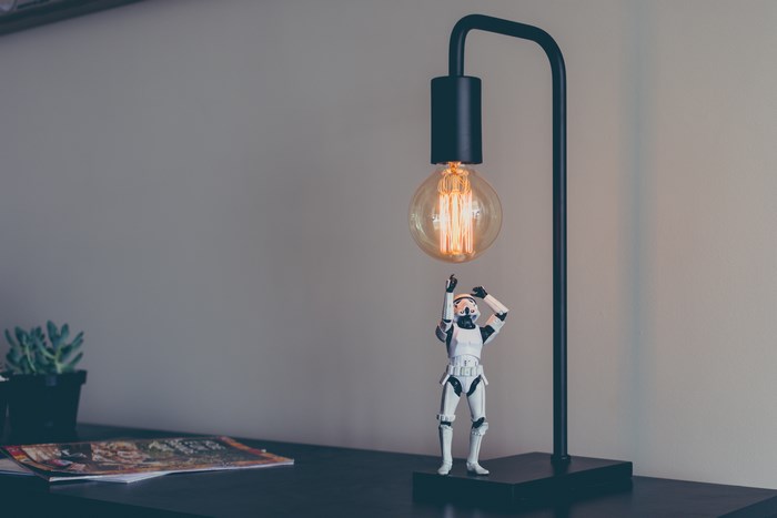 Stormtrooper action figure reaches for a light bulb