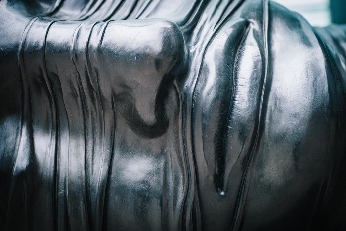 Close-up of a metallic sculpture with draped fabric texture