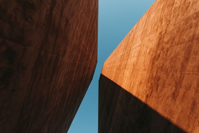 Two concrete structures against a blue sky
