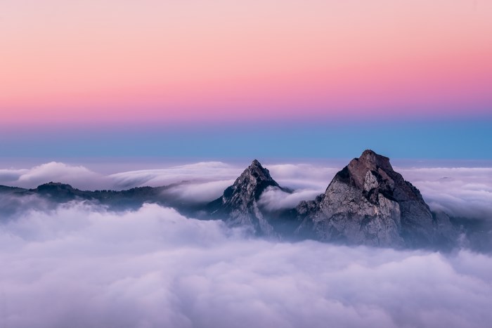 Mountains above clouds at sunset 4K