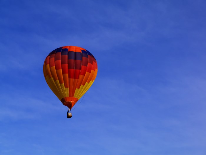 Hot air balloon floating in a blue sky