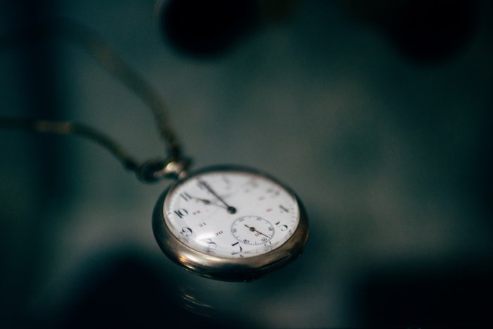 Close up of a vintage pocket watch with a watch chain