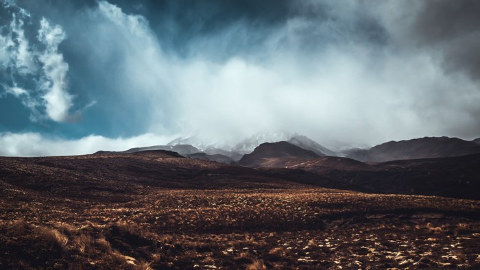 Mountain landscape with clouds and dry grass