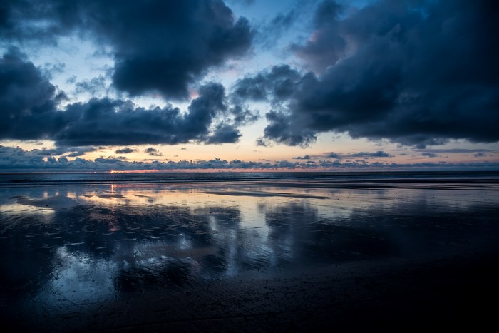 Cloudy Sunset Reflection on a Wet Beach