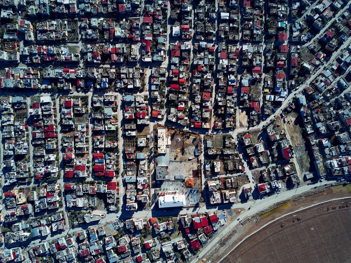 Aerial view of a dense suburban neighborhood with red rooftops