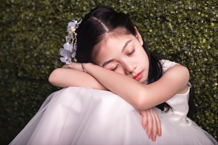 Girl in a white dress sleeping
