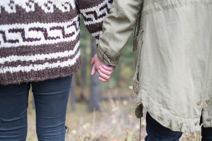 Couple holding hands outdoors