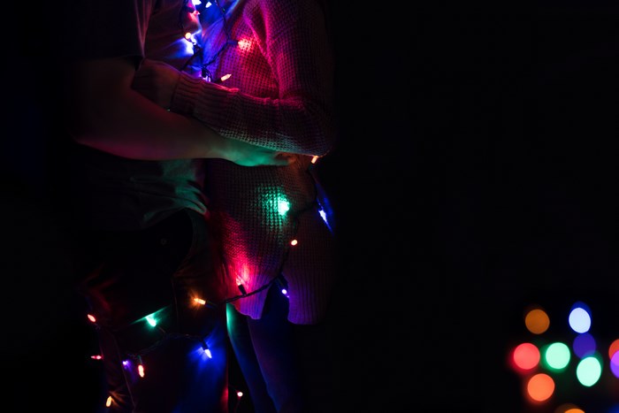 Couple embracing with colorful fairy lights