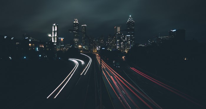 Atlanta cityscape at night with light trails on highway