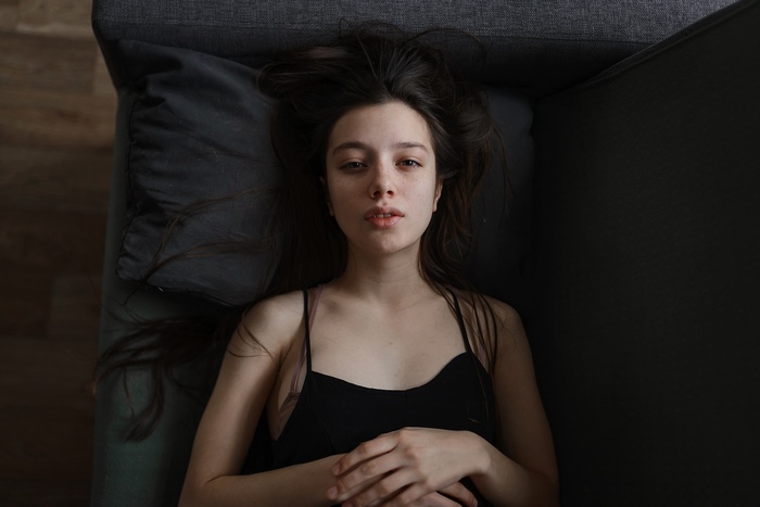 Woman lying on a couch with black hair