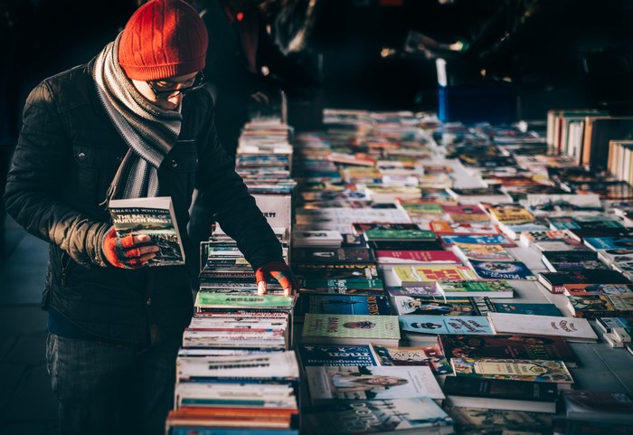 Man browsing books at an outdoor market