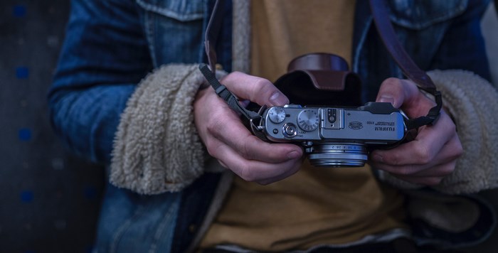 Person holding a Fujifilm camera