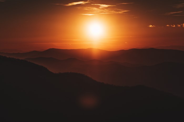 Sunset over layered mountain ranges