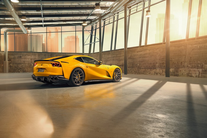 Yellow Ferrari 812 Superfast parked in a warehouse