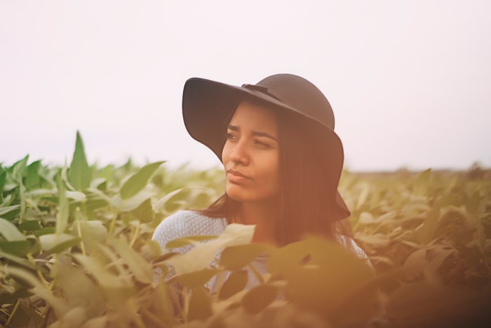 Woman in a hat in a field of crops
