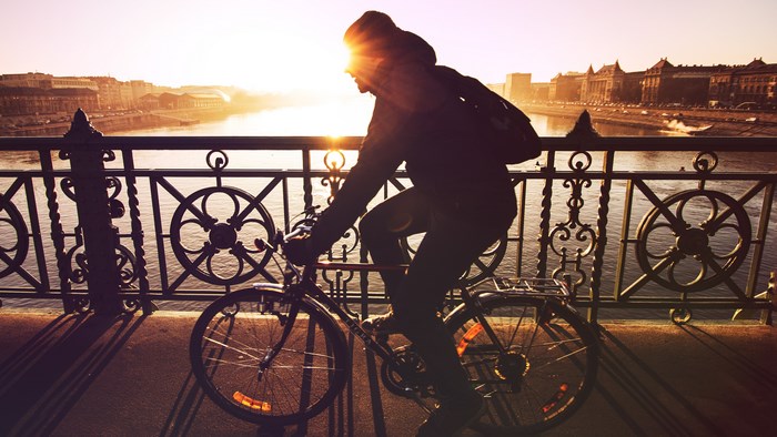 Cyclist on a bridge at sunrise in Budapest