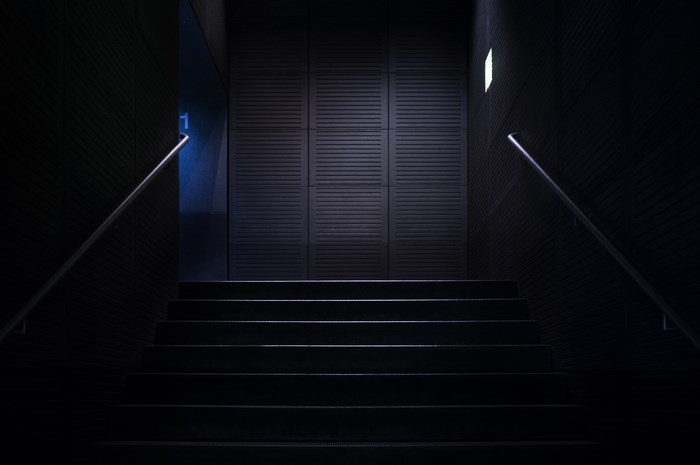 Dark Staircase with Blue Light and Railings
