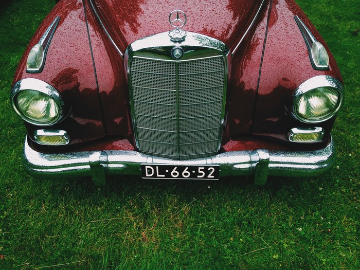 Vintage Mercedes-Benz with Raindrops on Green Grass