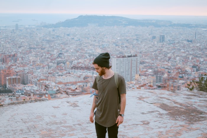 Man with beard and beanie overlooking Barcelona city