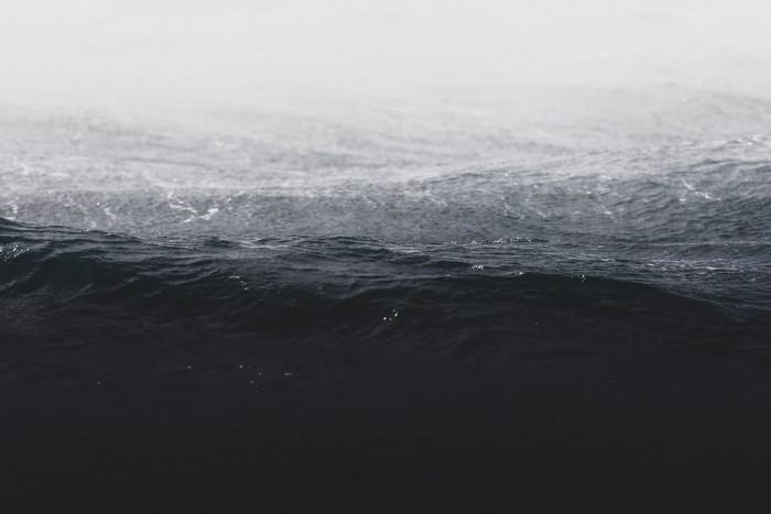 Dark Ocean Waves Under a Misty Sky